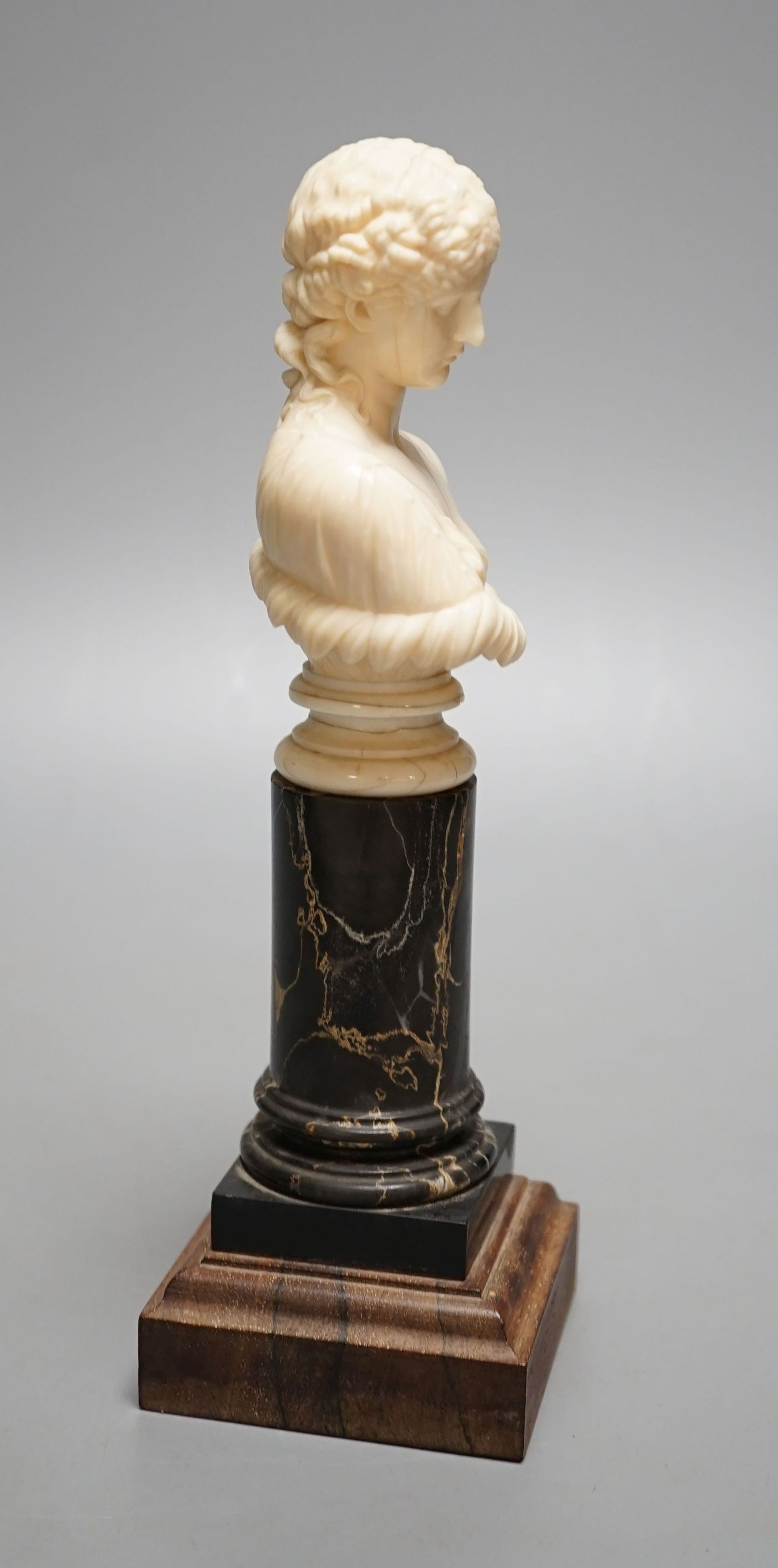 A 19th-century Dieppe ivory bust of Clytie, on a marble and rosewood pedestal, after the model in the British Museum - 24.5cm tall